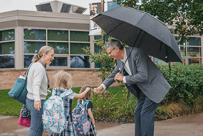 Dr. Hudson greets a Lower School family