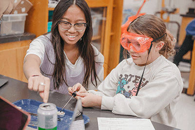 Middle School students working with fire in a lab.