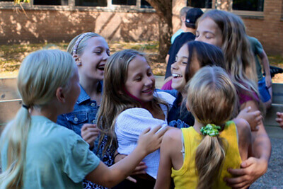 Middle School students are hugging at recess