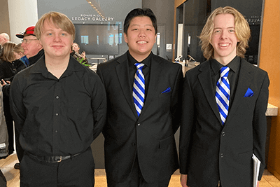 Truman Wilgocki '26, Chali Yang ’26, and Warner Reid ’26, who performed with the All-State Choirs. 