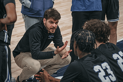 Alumni Cooper Olson coaching basketball.