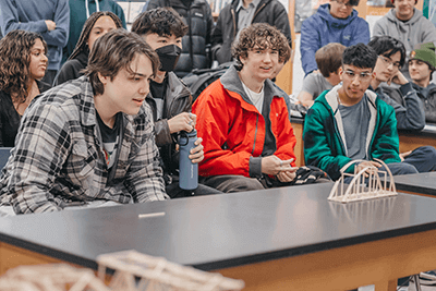 Upper School students watch on during Physics bridge testing. 