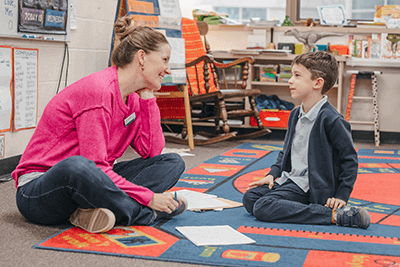 Lower School teacher interacts with a student. 