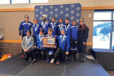 The MPA Nordic ski team and its third-place finish plaque at state. 