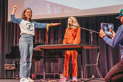 A student showing Middle School teacher her magic at the talent show. 