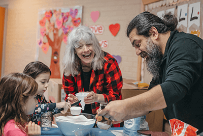 A parent and teacher work with Lower School students. 