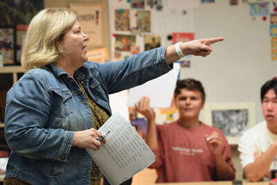 Upper School Spanish teacher working with students in class