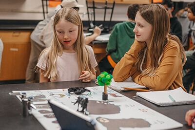 Middle School students viewing a peer's science project