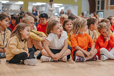 Lower School students listening at a CHAMP Assembly. 
