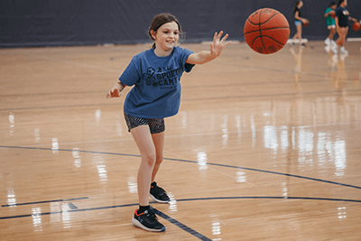 Lower School student playing basketball