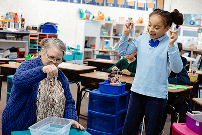 A Lower School student cheers on her project