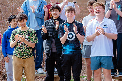 Upper School students clapping. 