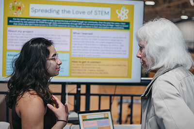 Senior explaining her senior service project to a visitor