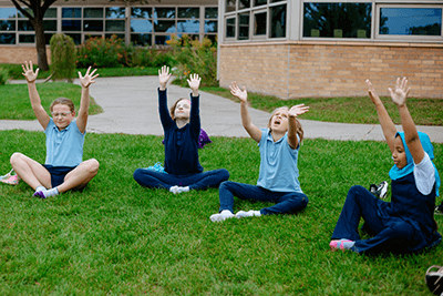 Lower School students engaging in yoga.