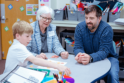 A Lower School parent and grandparent playing with a child. 
