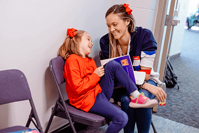 Feature image of A Lower School student and her parent laughing