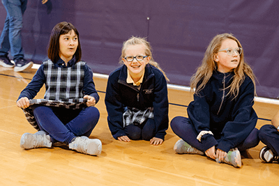 Three Lower School students excited for their activity.