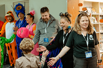 Parents cheer on Lower School students during the Halloween Parade. 