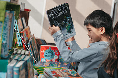 A student looks at a book during the MPA Book Festival. 