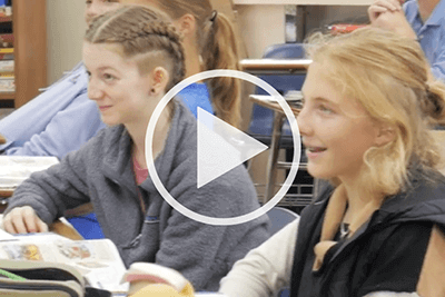 Two Upper School students engaged in classroom learning.