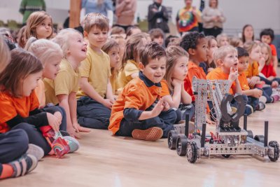 Kindergarten students at an assembly with a STEM Robot