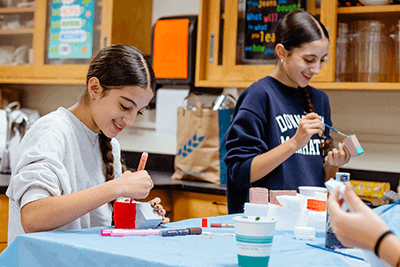 Middle School students painting a project.