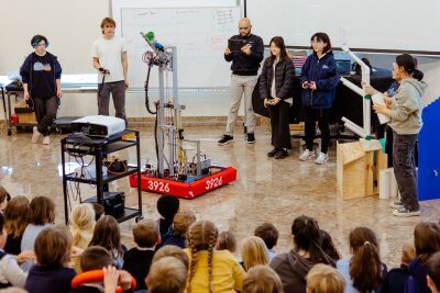 Upper School Students with a robot