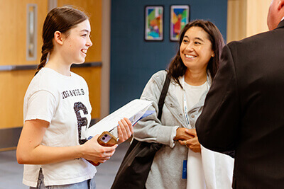 Mom and daughter talking to principal