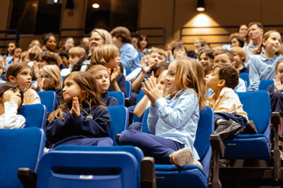 A group of Lower School students cheering. 