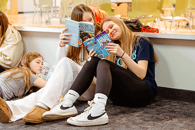 A pair of students reading together
