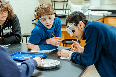A pair of Middle School boys doing an experiment.
