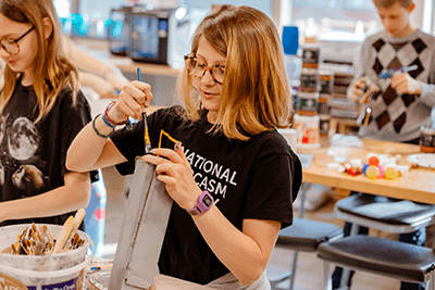 A student painting a project.