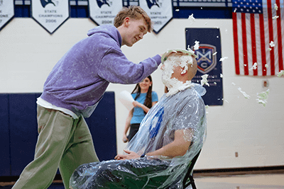 A student pies a teacher during SnoDaze. 