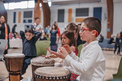 A student drumming at Cultural Celebration Day. 