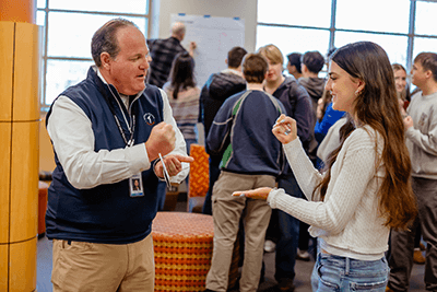 A student and faculty member playing a game