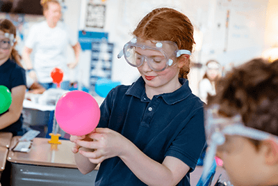 A girl conducting a chemistry experiment. 