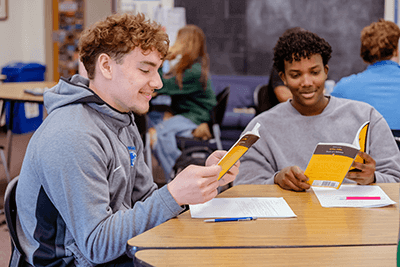 Two students reading in class. 