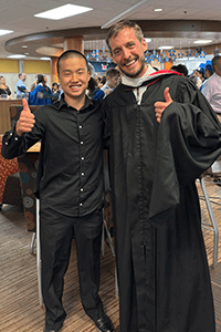 An MPA student and teacher pose for a picture. 