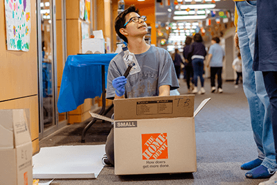 A boy holding up a bottle