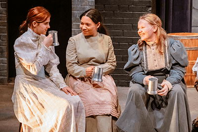 Three students acting in a musical.