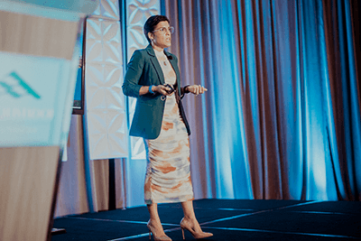 Mirdalys Tweeton '08 speaks at a conference