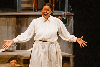 A student singing during a musical performance.