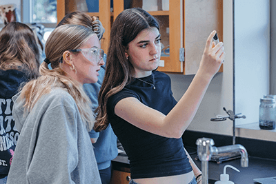 Two Upper School students working on a lab