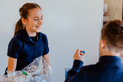 A student examining a piece of a project. 