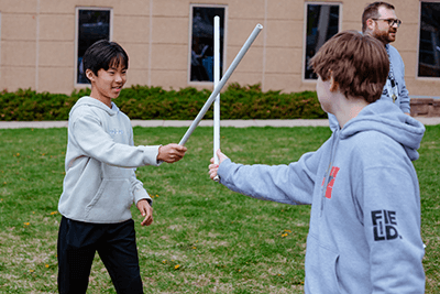 Two students engaging in choreography.