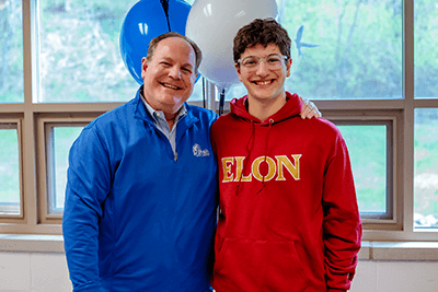 A student and the Upper School director smiling.