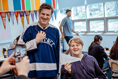 A student and teacher posing for a picture. 