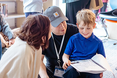 First grader reading poetry to parents