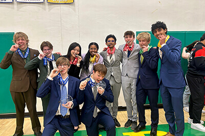 MPA's speech team posing with their medals.